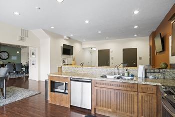 Kitchen with a white dishwasher and wooden cabinets